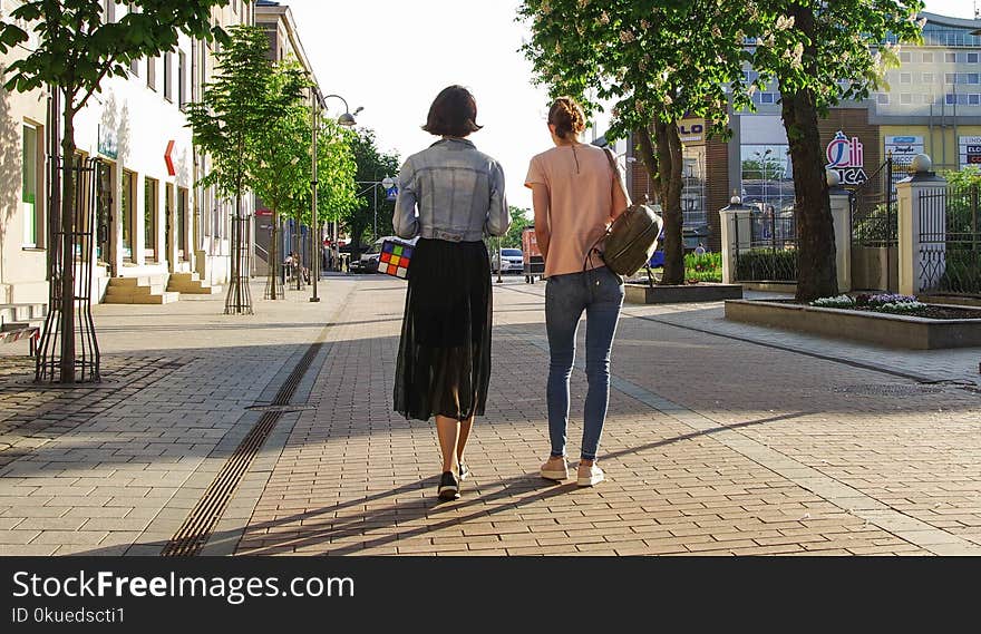 Photo of Women Walking Down the Street