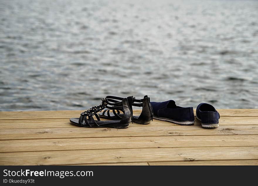 Two Pairs of Sandals on Wood Floor