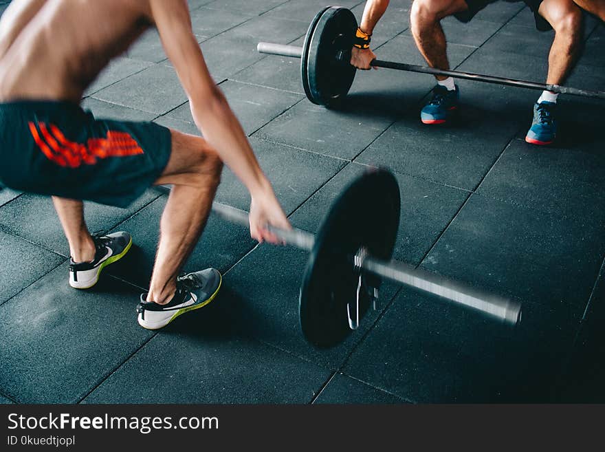 Man Wearing Black Shorts Lifting Heavy Barbells