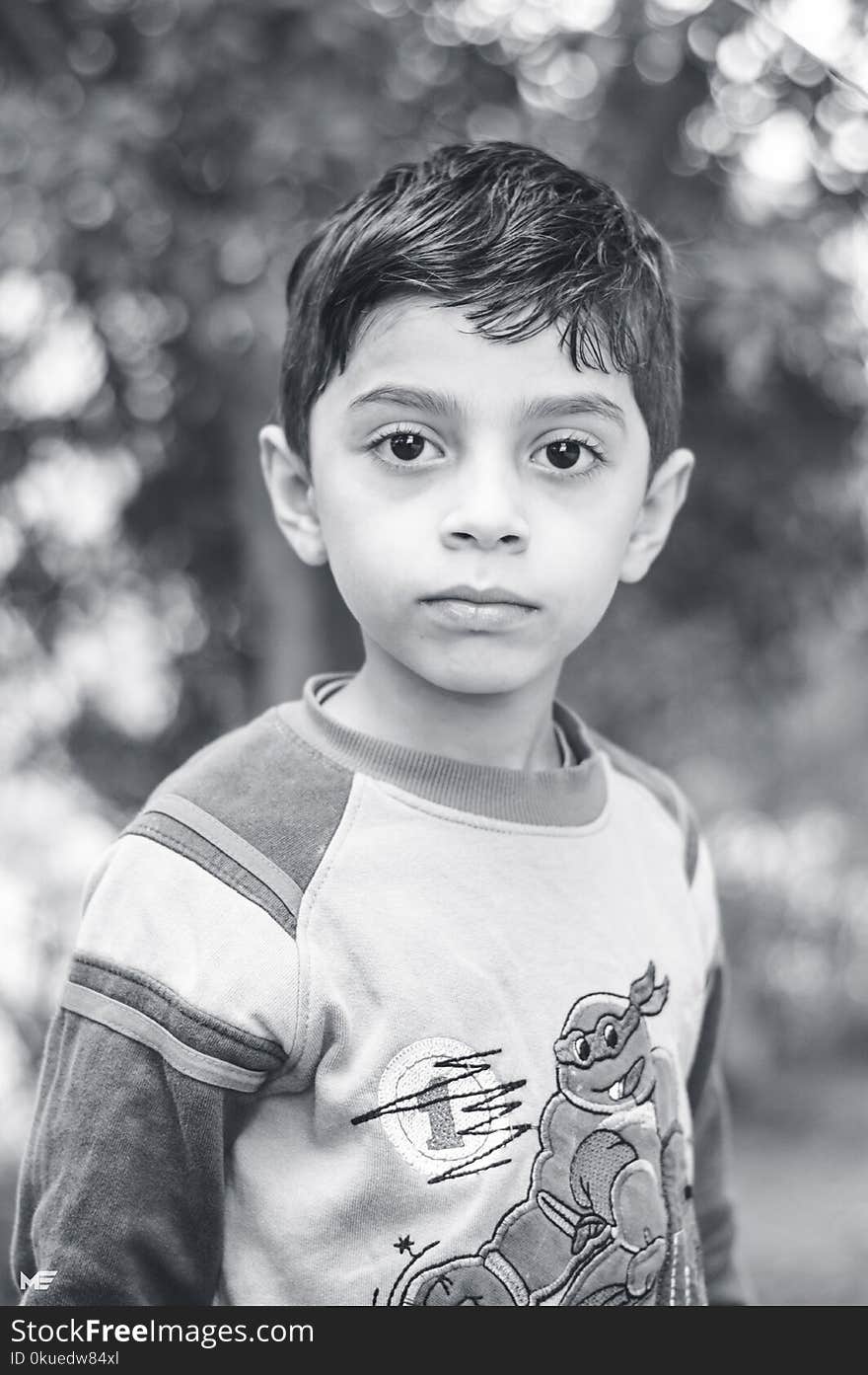 Grayscale Photo of Boy Wearing Long-sleeved Top