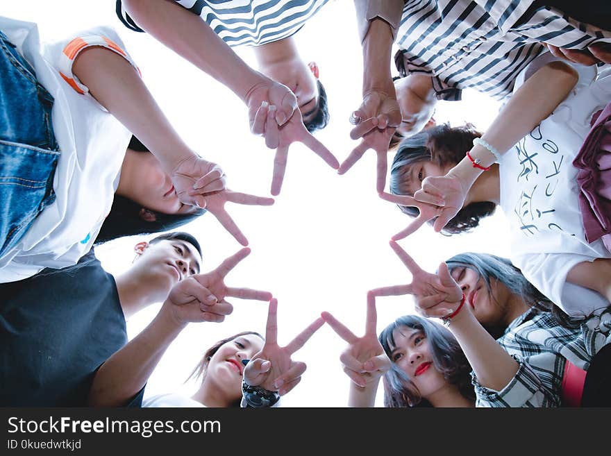 Group of People Forming Star Using Their Hands