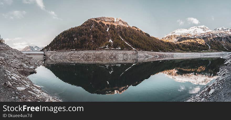 Green Covered Mountain Reflected on Calm Water Under Clear Sky Landscape Photo