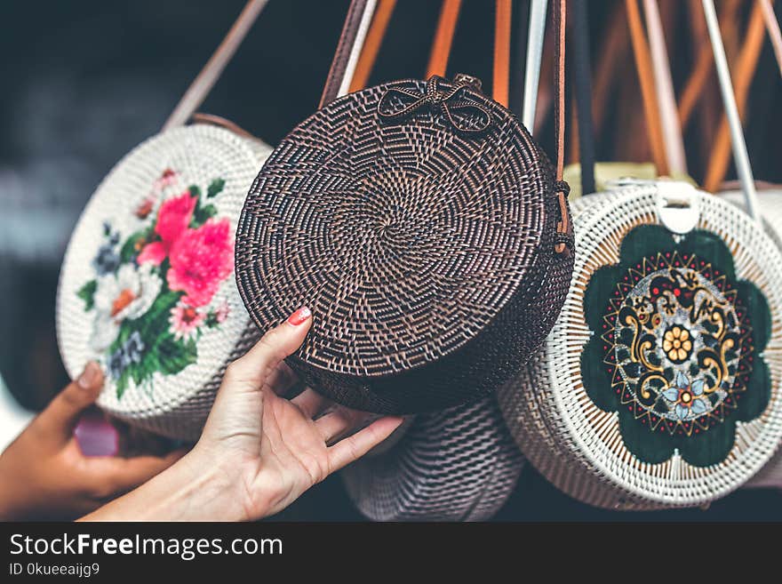 Person Holding Round Black Wicker Crossbody Bag