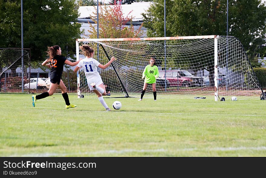 Three Women Playing Soccer Game