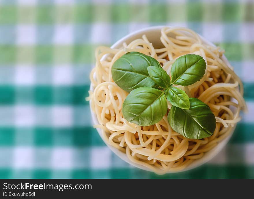 Selective Focus Photo of Noddles With Green Leaf Toppings