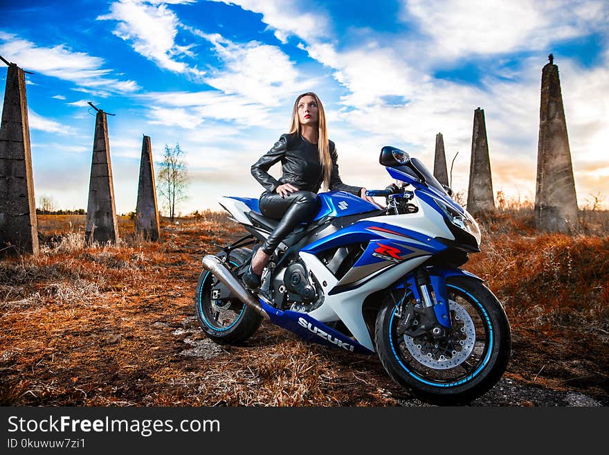 Woman In Black Leather Jacket Sitting On Blue And White Suzuki Gsx-r