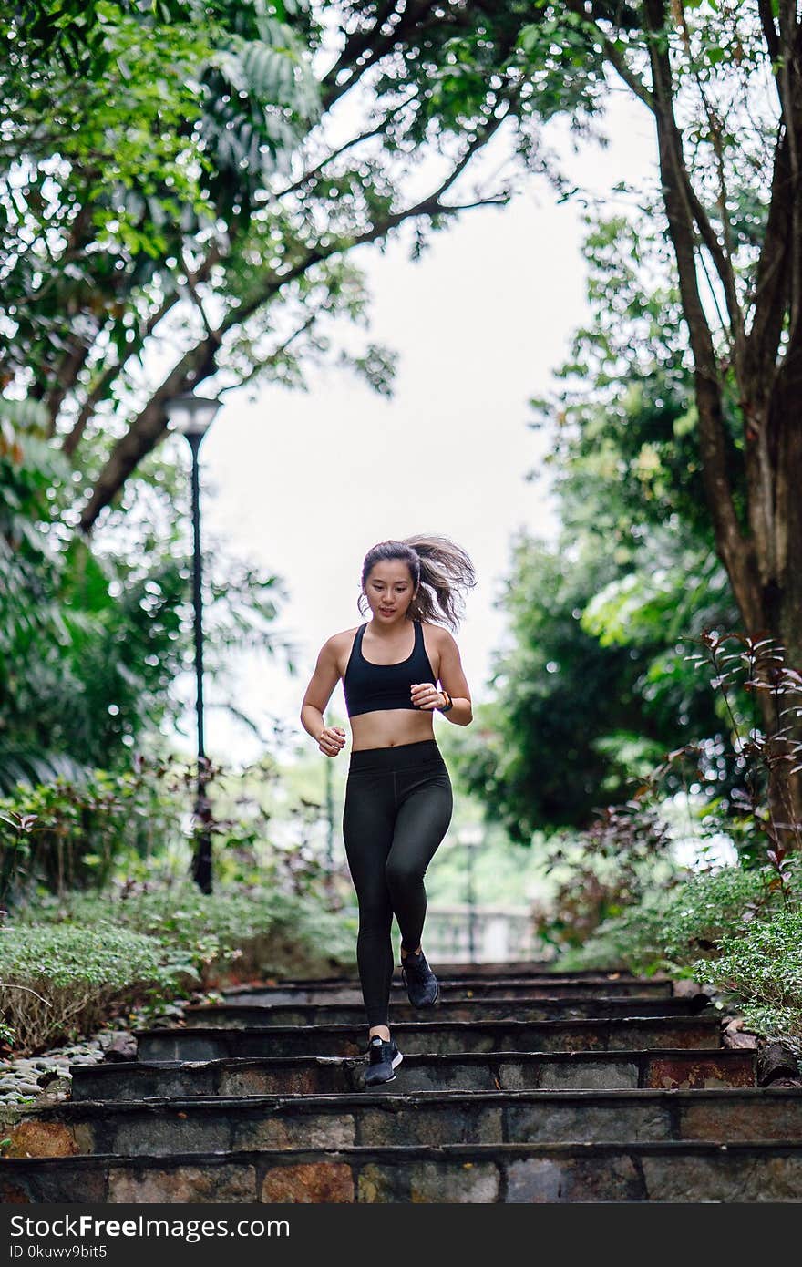 Photo of Woman Jogging Down Stairs