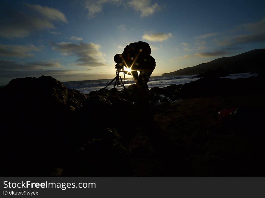 Man Taking Picture of the Ocean