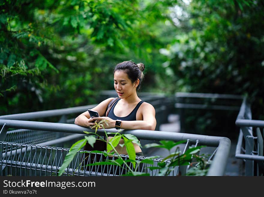 Woman Wearing Sports Bra Looking at Phone