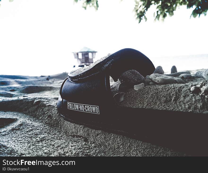 Black Textile on Gray Sand