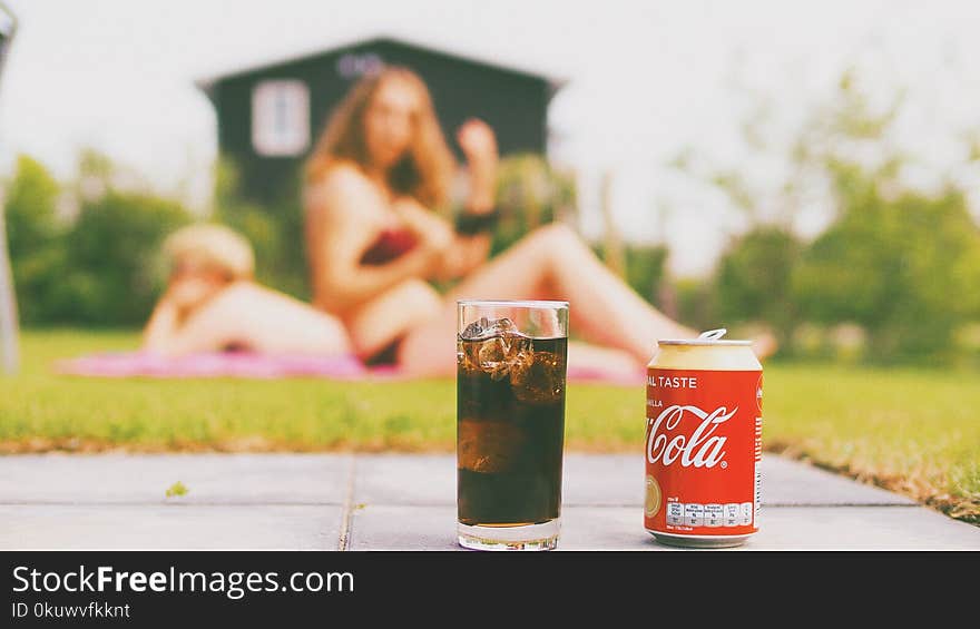 Coca-cola Can and Drinking Glass Filled With Coke