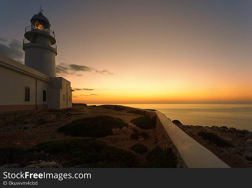 White Concrete Lighthouse during Golden Hour