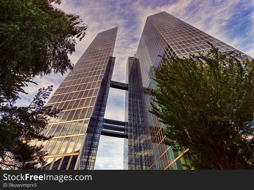 Low Angle Photo of Two Clear Glass Skyscrapers Under Clear Blue Sky