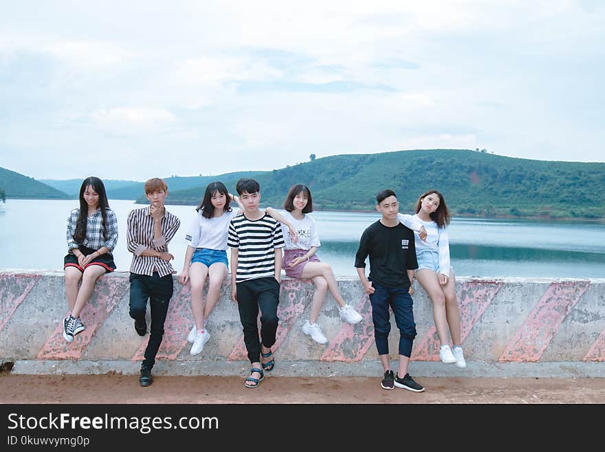 Photo of Four Women and Three Men Standing on Bridge