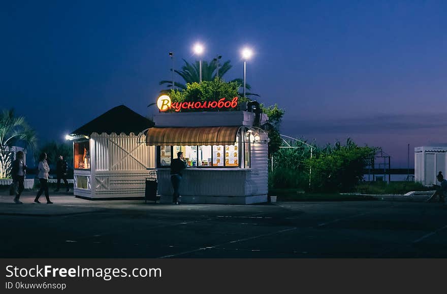 White Food Stall With Lights Open during Nighttime