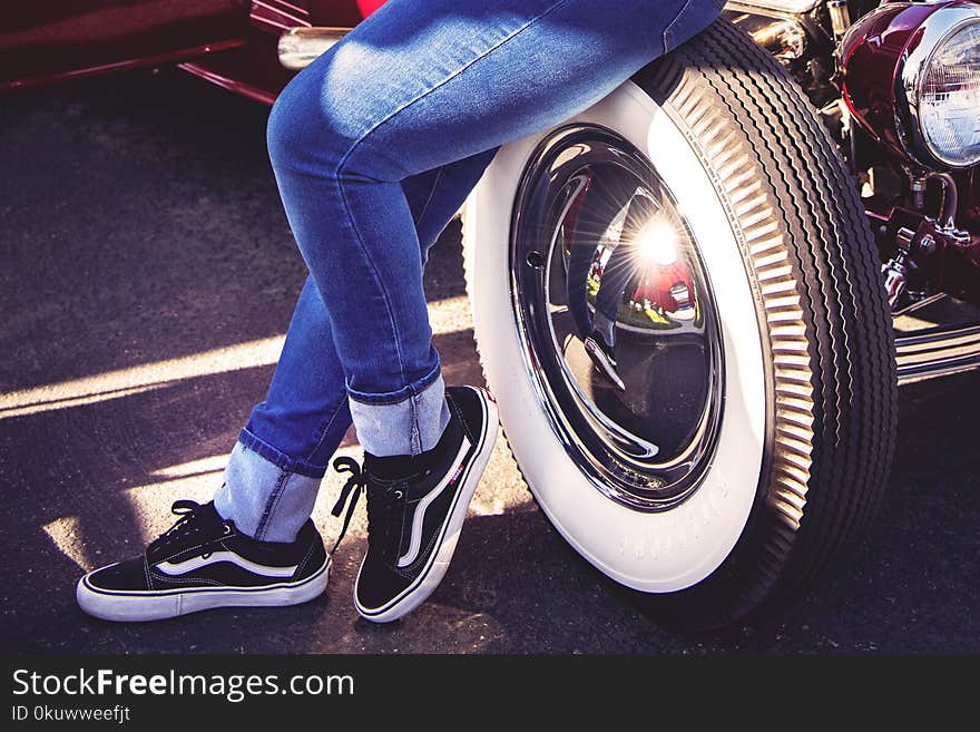 Person Sitting on Vehicle Wheel