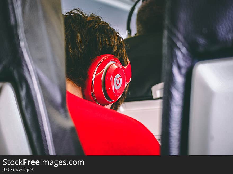 Man Wearing Red Beats By. Dre Headphones