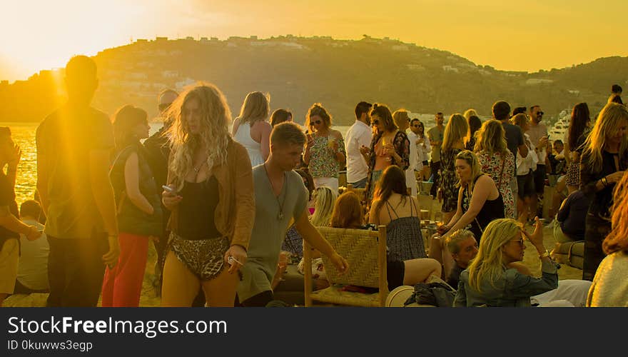 Crowd of People Gathering during Golden Hour