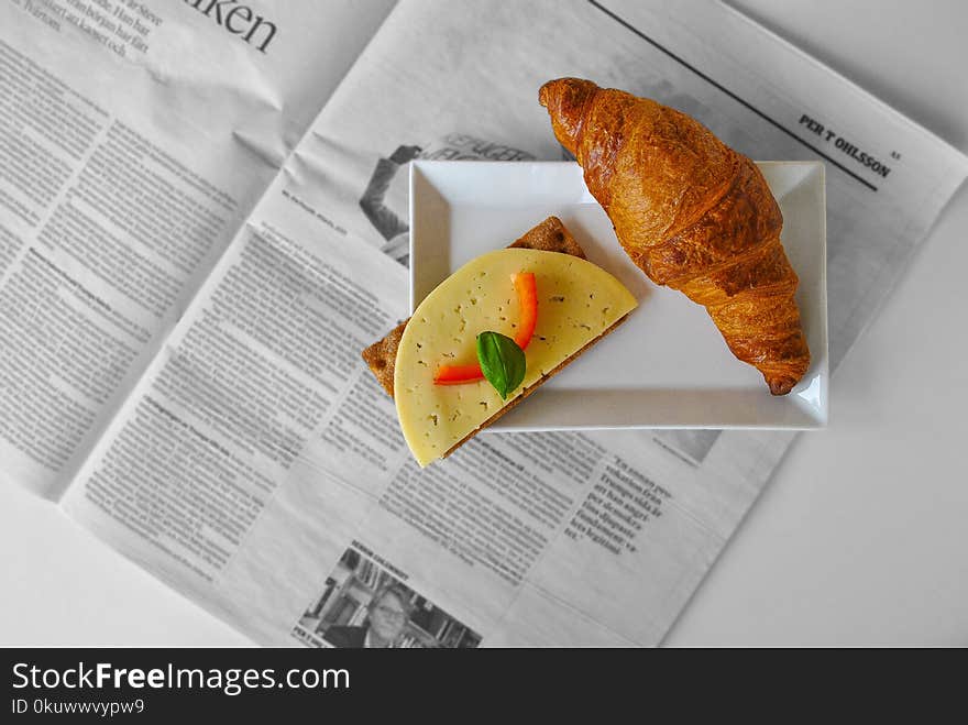 Croissant Bread and Sliced Cheese Placed on White Ceramic Saucer