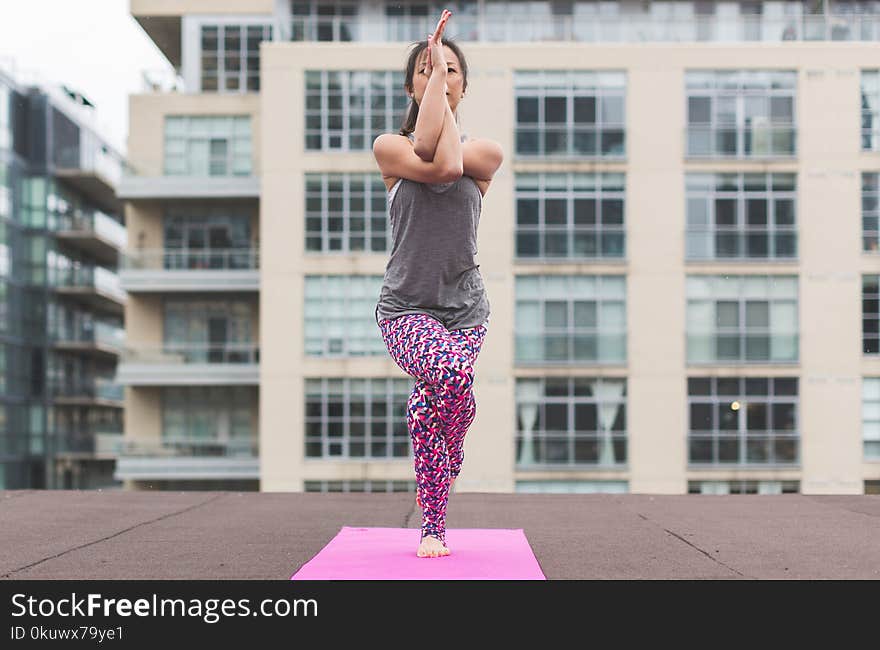 Woman in Gray Top and Pink Pants Yoga on Pink Mat