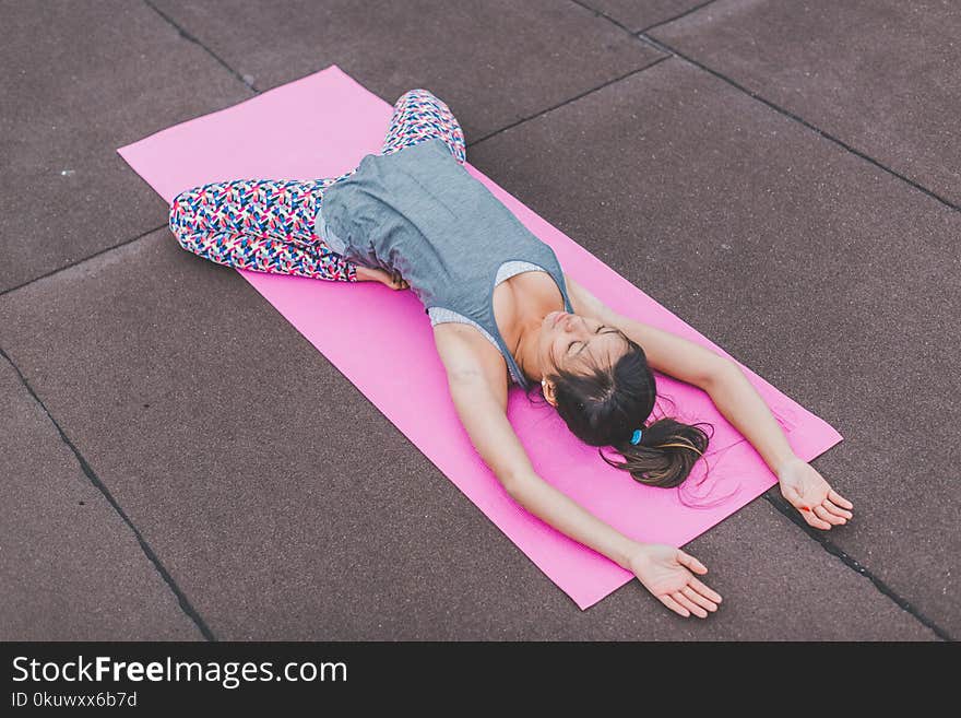 Woman Lying on Pink Yoga Mat