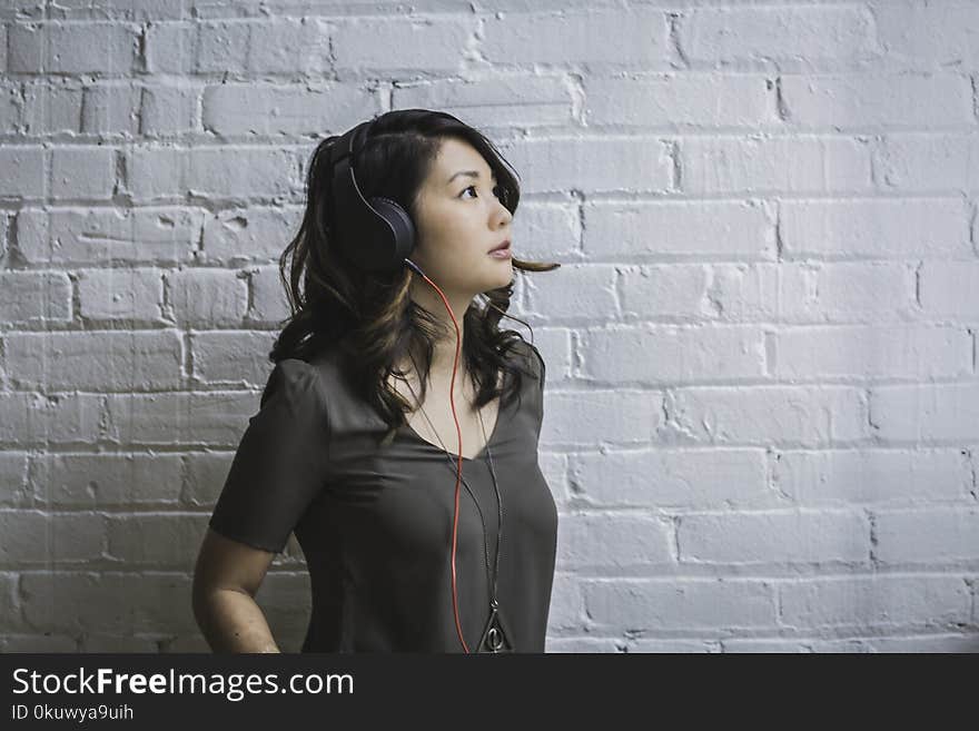 Woman Looking Up While Wearing Headphones