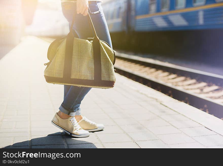 Woman holding a bag at a train station