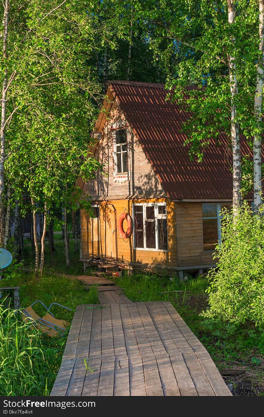 Old wooden fisherman`s house on the lake and a wooden pier