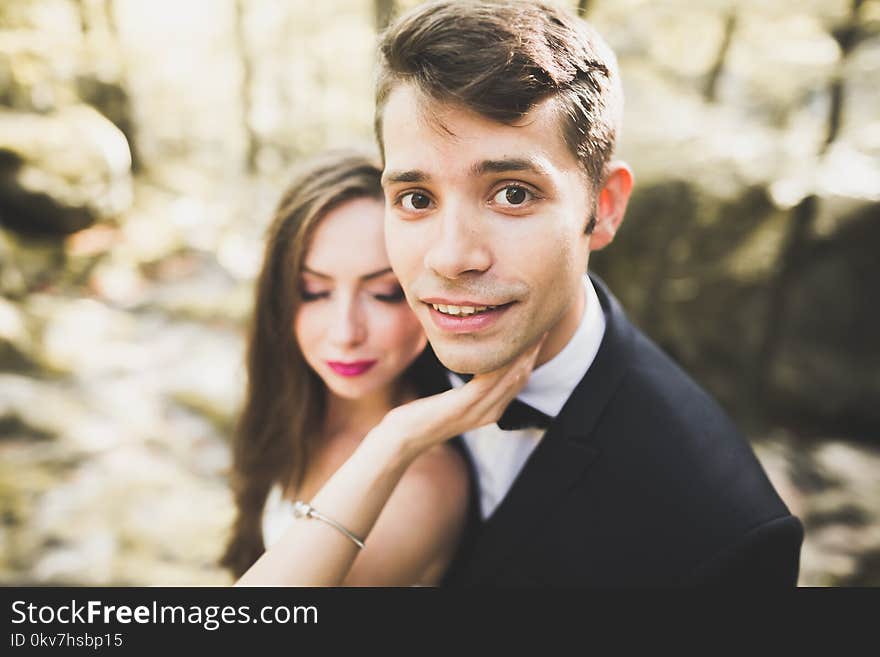 Beautiful, perfect happy bride and groom posing on their wedding day. Close up portrait.