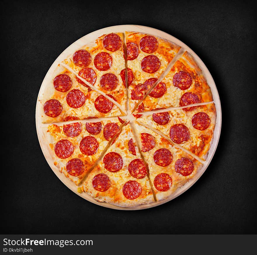 Pepperoni pizza on a black background.