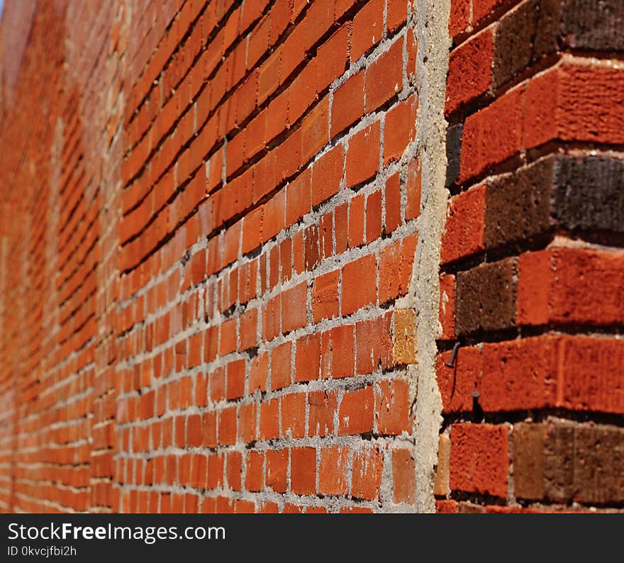 A photo of an old red brick wall showing blur and mortar. A photo of an old red brick wall showing blur and mortar.