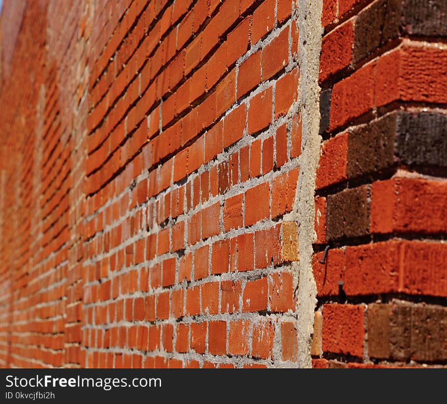 A antique red brick wall showing the old concrete In a blur