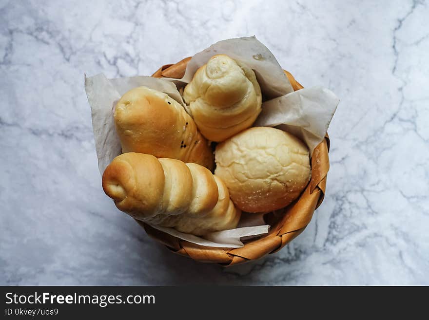 Four Brown Pastries in Brown Wicker Basket