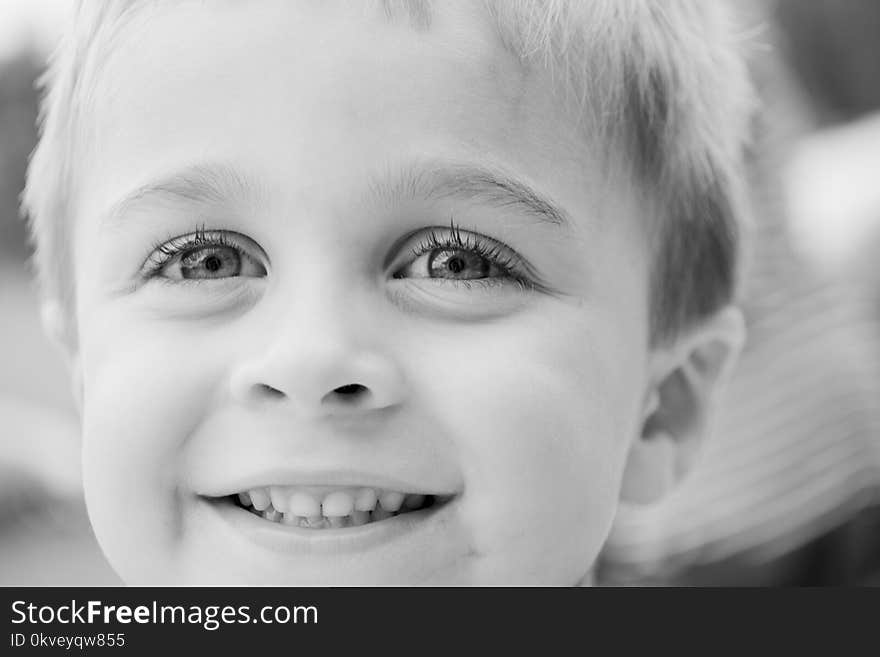 Grayscale Photo of Toddler Smiling