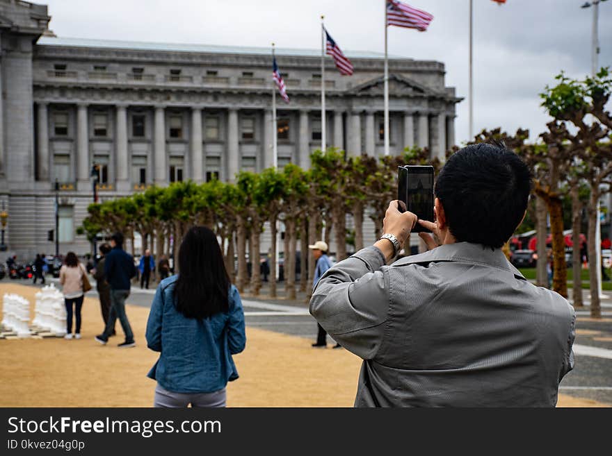 Man Using Smartphone to Capture Photo