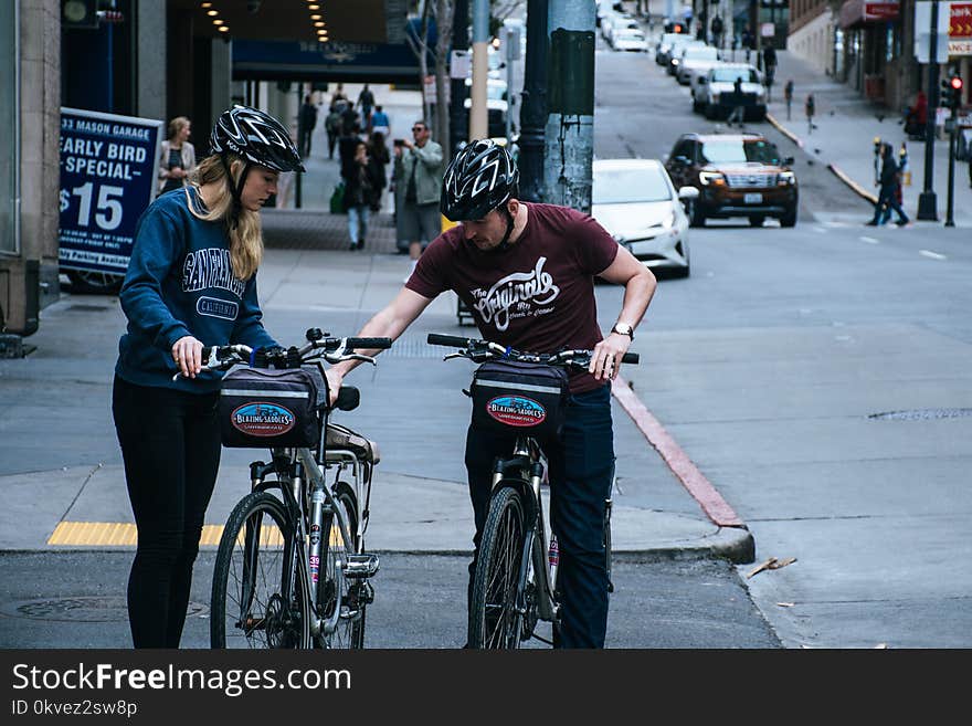 Man In Maroon Crew-neck T-shirt Beside Woman In Blue Sweatshirt At The Street