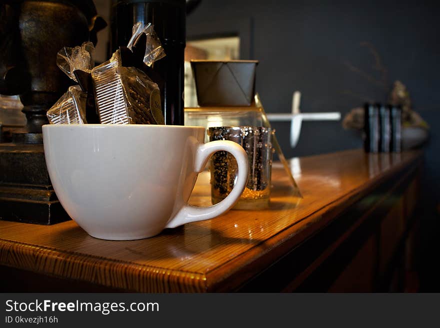 White Ceramic Cup on Brown Wooden Surface