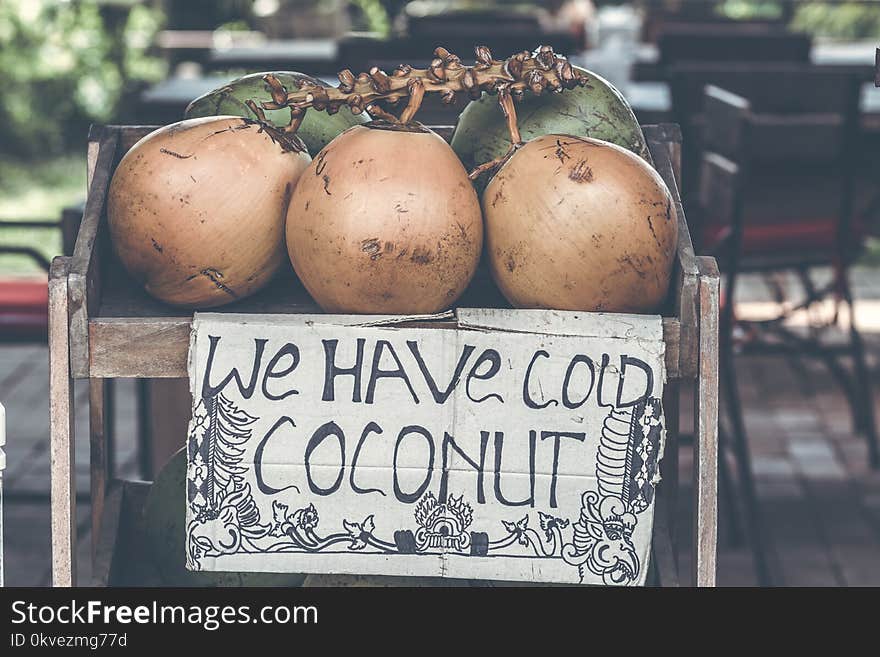 Tan Coconuts Placed Atop Brown Wooden Table