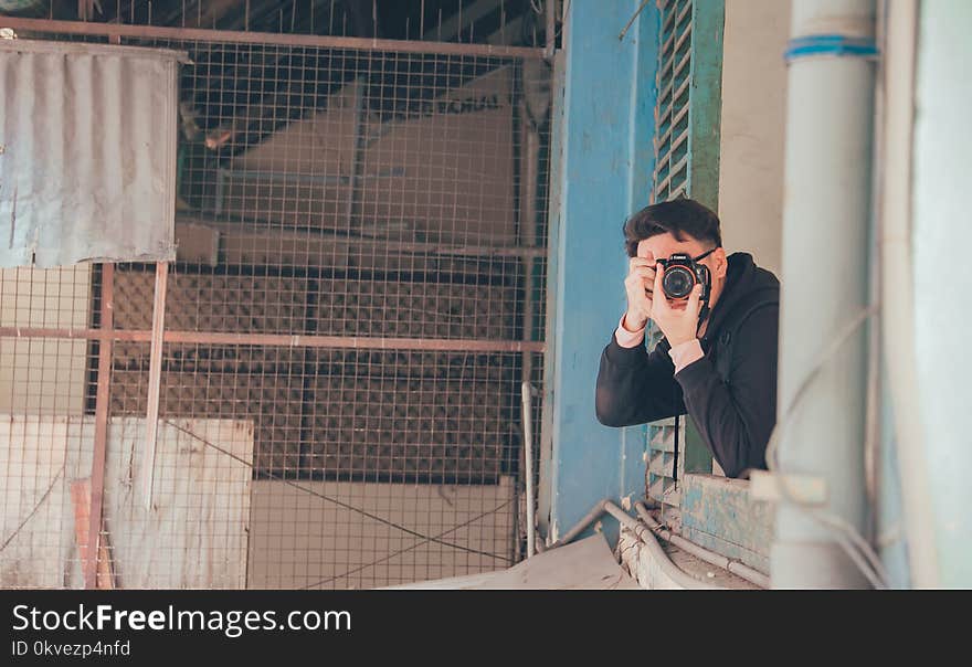 Man Holding Dslr Camera