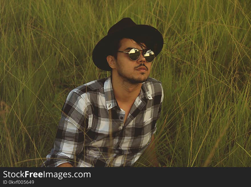 Photo of Man Lying Down on Green Grass Field