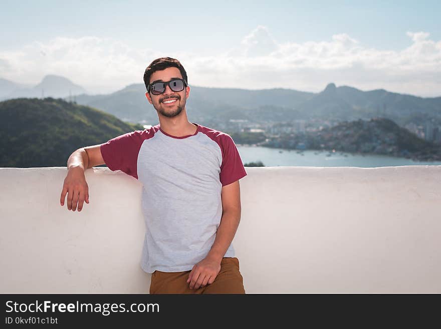 Man Wearing Gray and Red Crew-neck Shirt Smiling