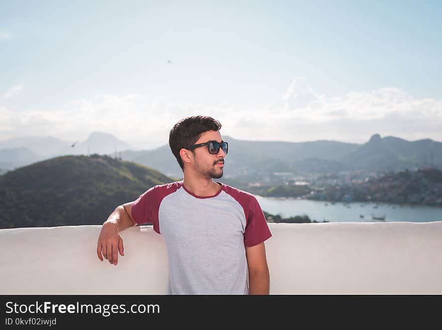 Man in White and Red Crew-neck T-shirt in Shallow Focus Photography