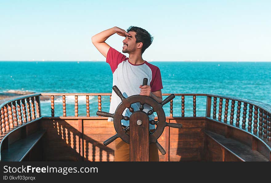 Man Holding Ship&#x27;s Wheel