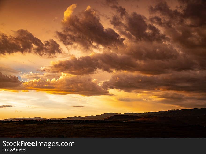 Orange Sunset With Clouds in Sky