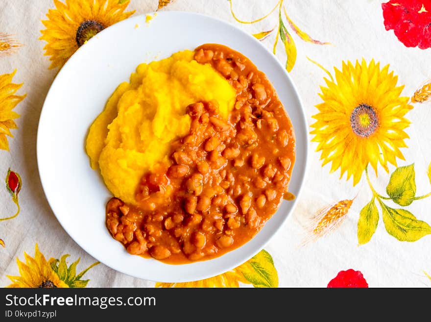 Traditional Italian poor dish with beans and polenta on tablecloth. Traditional Italian poor dish with beans and polenta on tablecloth