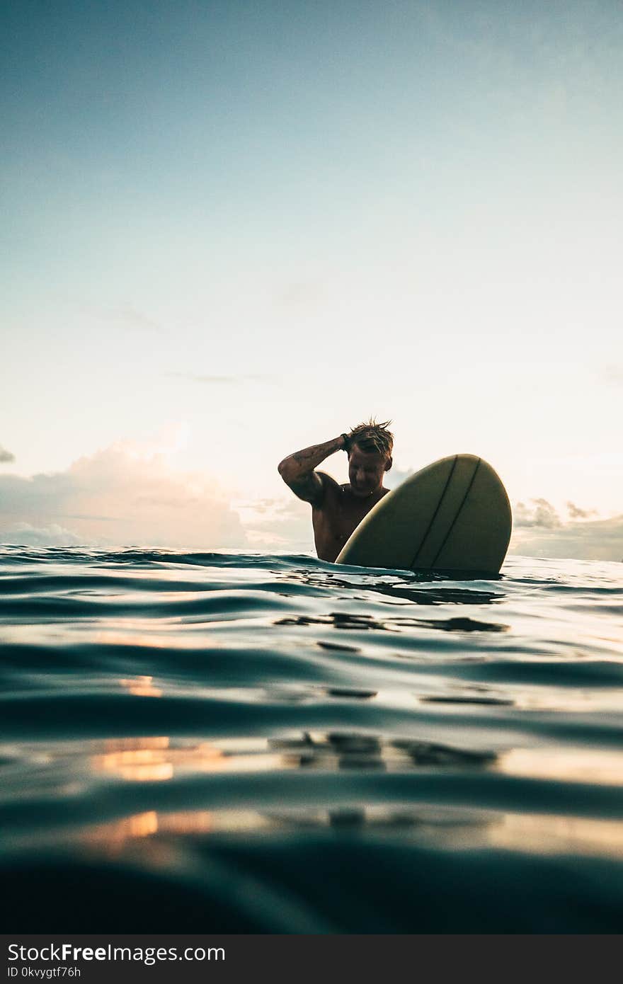 Man Holding White Surfboard