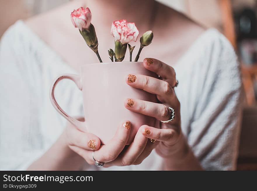 Woman Wearing White Shirt Holding Pink Mug With White Petaled Flowers