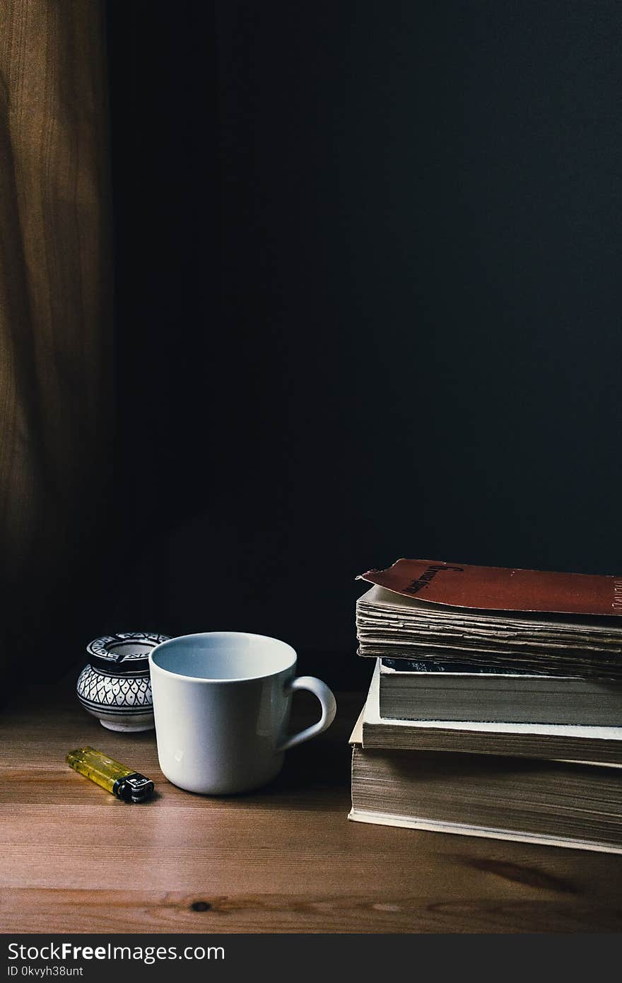 White Ceramic Mug and Yellow Disposable Lighter