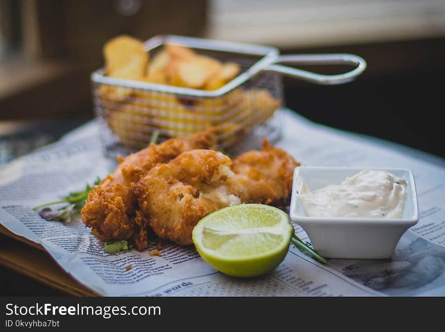 Fried Meat Beside Sliced Lemon and White Mustard