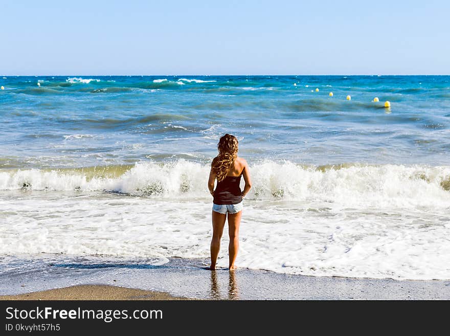 Photo of Woman Standing on Seashore